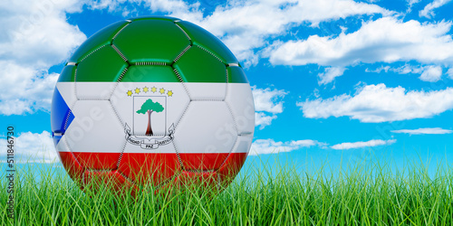 Soccer ball with Equatoguinean Guinea flag on the green grass against blue sky  3D rendering