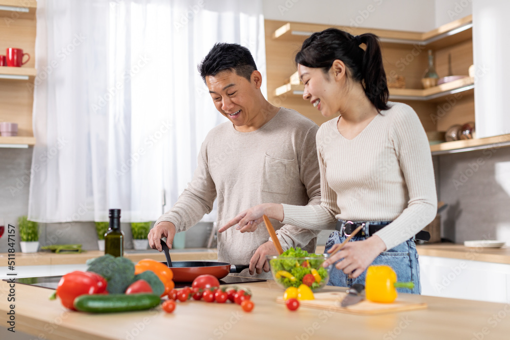Positive chinese family making food at home