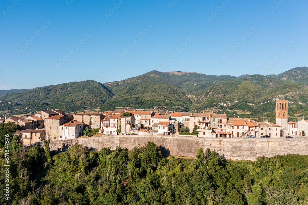 Breathtaking aerial view overlooking the town on top of the mountain. Aerial Drone view of scenic natural landscape with overlooking of architecture. Traveling in Italy, Europe