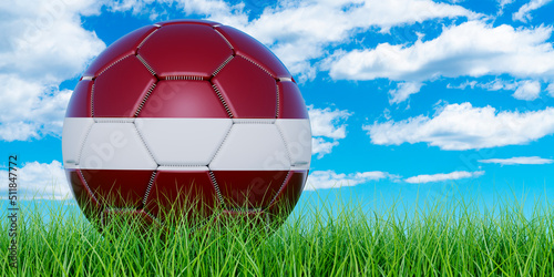 Soccer ball with Latvian flag on the green grass against blue sky  3D rendering