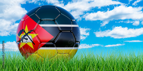 Soccer ball with Mozambican flag on the green grass against blue sky  3D rendering