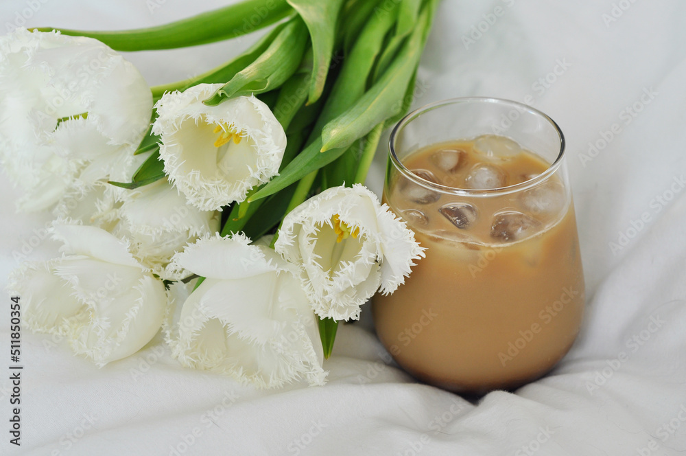 bouquet of beautiful white tulips with iced coffee