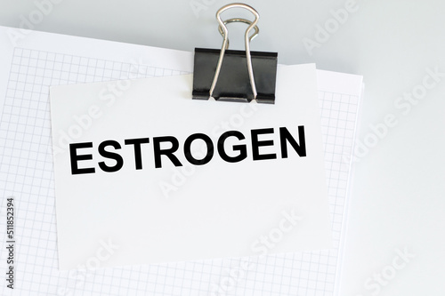 Text ESTROGEN on a card clip to blank sheets on a light table