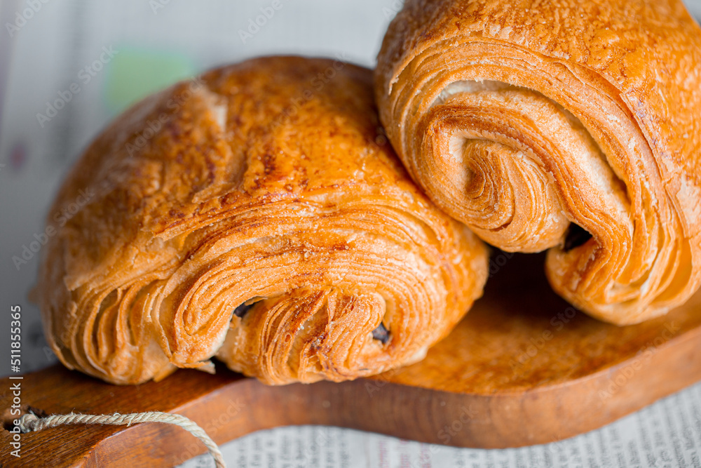 Fototapeta premium Croissant macro. French croissant with waves. Air baking. Croissant for puff pastry advertising. Croissant for a magazine.French breakfast with pastries. From puff pastry. Bun from France. Roll macro