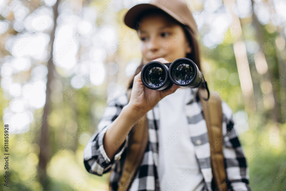 Girl looking through binoculars in park Girl looking through binoculars in park