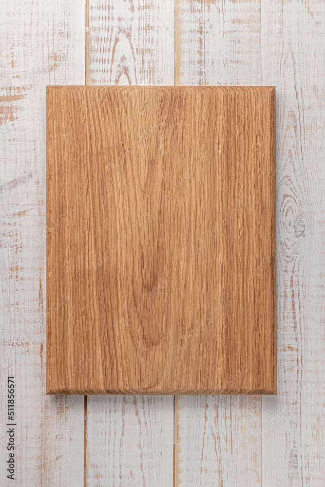 rectangular cutting board on a white wooden table. mockup of a food background with copy space, top view