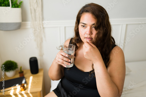 Sick young woman taking medication