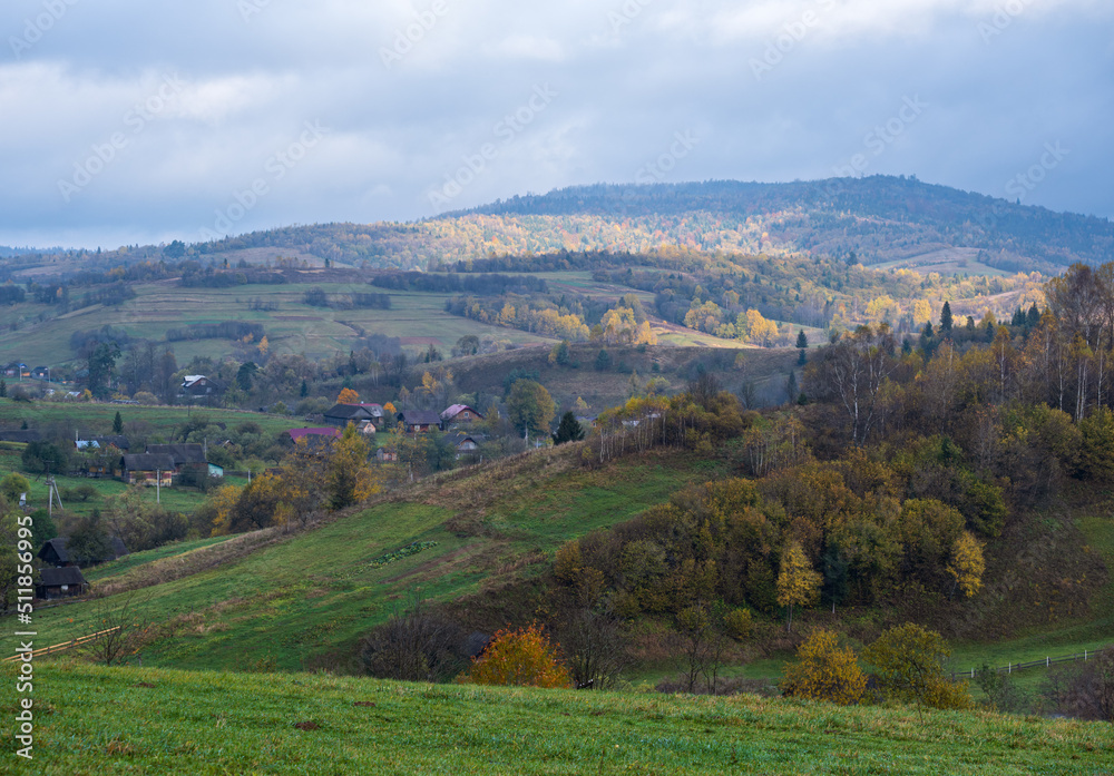 Obraz premium Cloudy and foggy autumn mountain countryside scene. Carpathians, Ukraine. Peaceful picturesque traveling, seasonal, nature and countryside beauty concept scene.