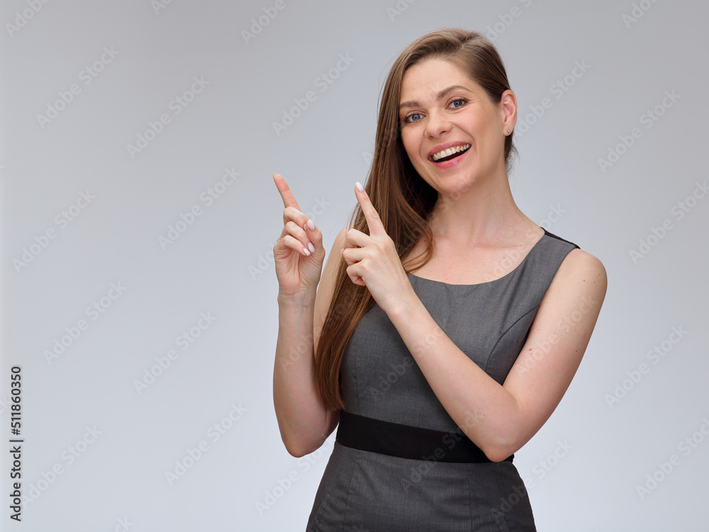 Happy woman in business dress pointing fingers up, smiling girl isolated portrait. Happy woman in business dress pointing fingers up, smiling girl isolated portrait.