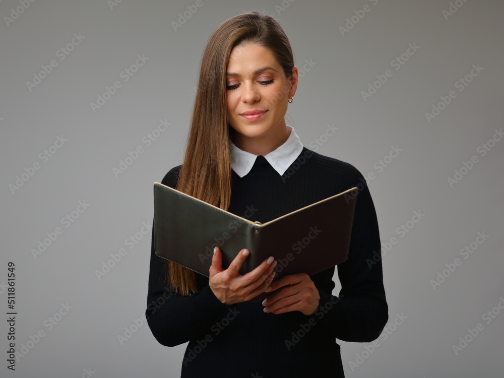 Strict teacher woman in black business suit reading book, isolated female portrait. Strict teacher woman in black business suit reading book, isolated female portrait.