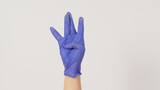 Hip-hop west coast hand sign and hand wear violet or purple latex glove on white background.
