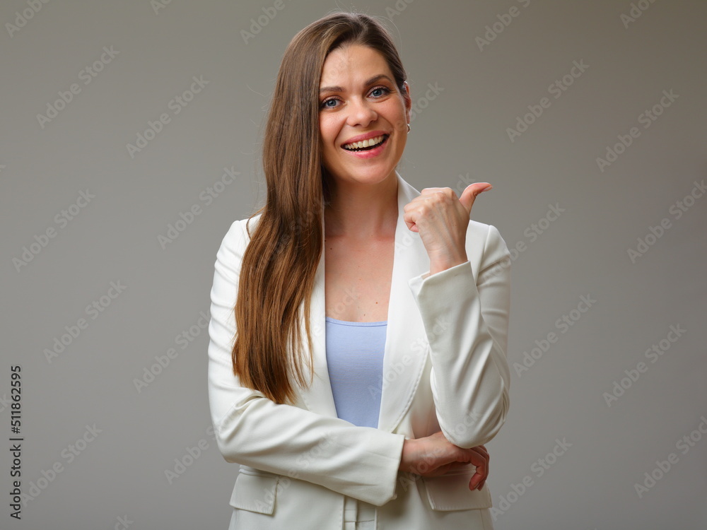 Smiling woman in white suit pointing finger up, studio isolated portrait. Smiling woman in white suit pointing finger up, studio isolated portrait.