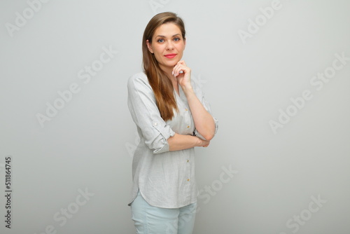 Thinking woman isolated portrait, young lady dressed pants and gray shirt.