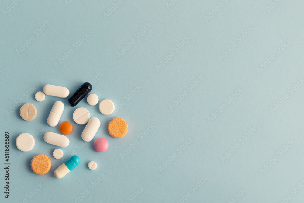 Pills on blue background. Pharmacy, pharmacology, medicine background with copy space. Pills on blue background. Pharmacy, pharmacology, medicine background with copy space.