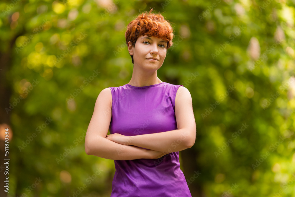 Self assured androgynous woman in summer park Self assured androgynous woman in summer park
