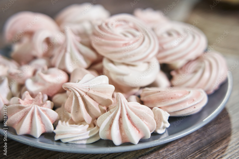 beautiful pink meringues on a plate close-up.