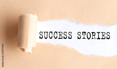 The text SUCCESS STORIES appears on torn paper on white background.