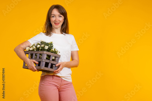 Woman with flowers in pot. ...