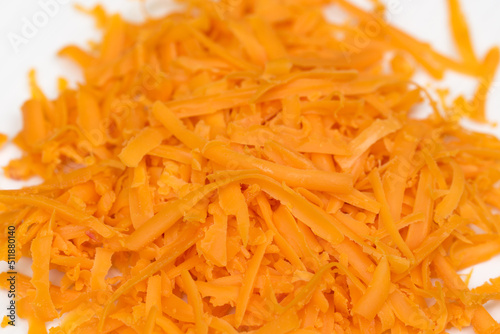 grated carrot on plate closeup selective focus