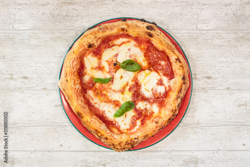 Italian handmade fresh pizza on wooden table high angle view