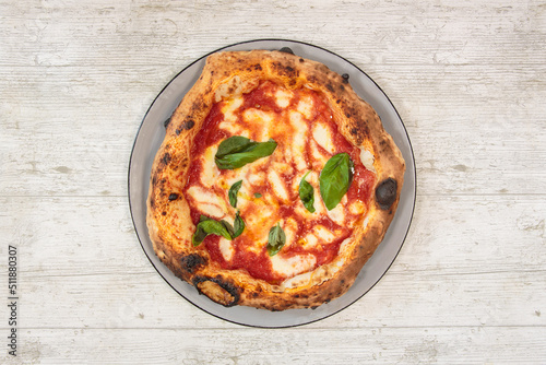 Italian handmade fresh pizza on wooden table high angle view