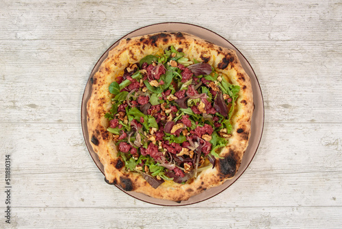 Italian handmade fresh pizza on wooden table high angle view
