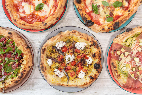 Italian handmade fresh pizza on wooden table high angle view