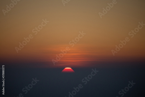 The view of sunset with the cloud with the red sky in the evening. © guidenuk
