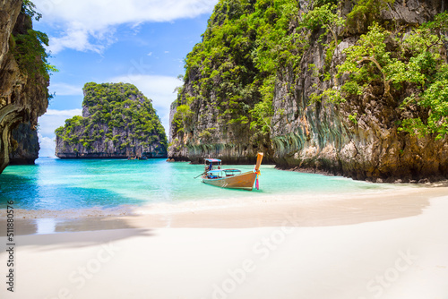 Thai traditional wooden longtail boat and beautiful beach in Phuket province, Thailand.