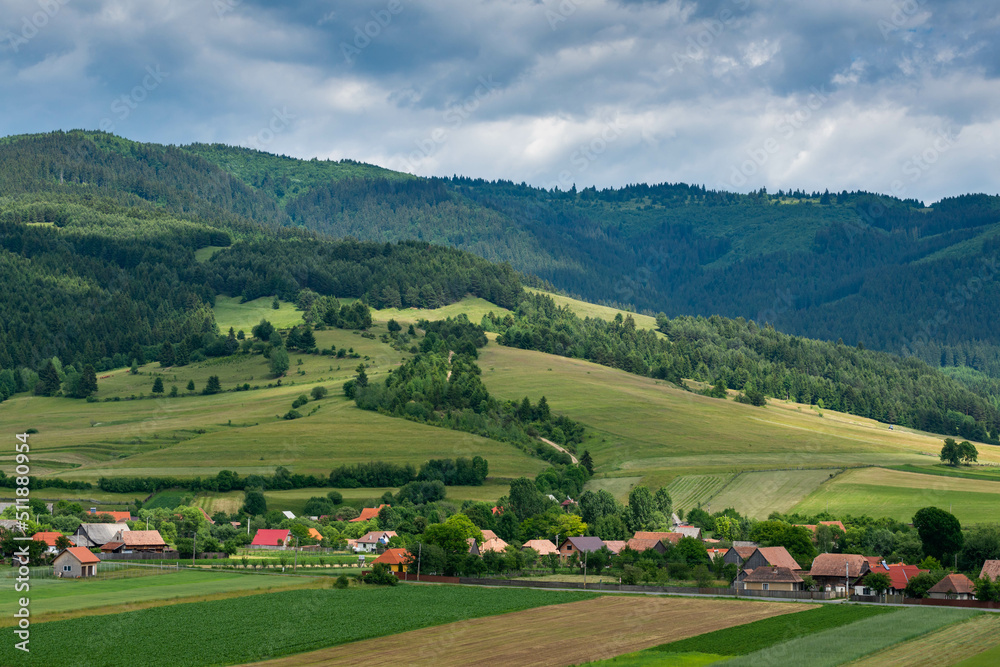 Agricultural fields, small hungarian village at summertime in Transylvania, Romania.
