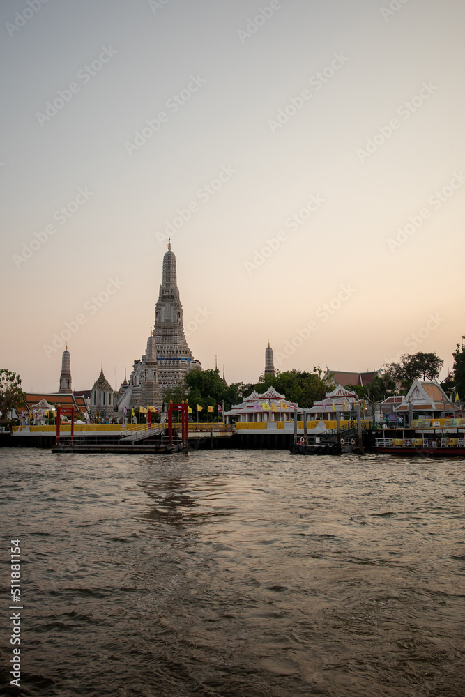 The view of the famous temple called Wat Arun located next to the grand river called chao Phraya in Bangkok city , Thailand. 