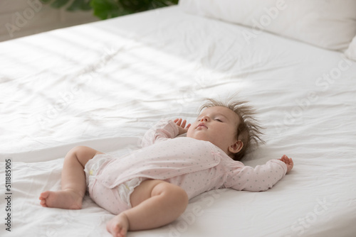 Bild auf Leinwand Close up shot peaceful babygirl in bodysuit and diaper falling asleep alone in bedroom, lying on bed looking carefree deep in sweet dreams