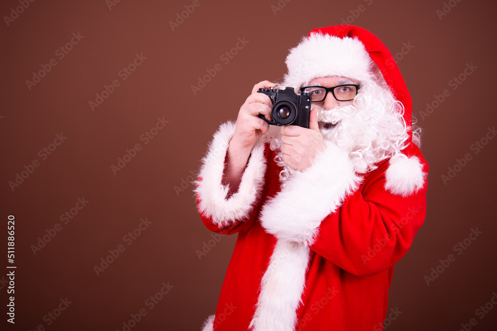 Funny santa claus takes pictures.
