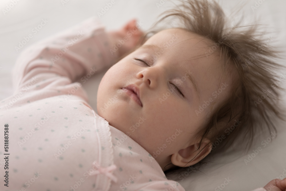 Close up shot serene peaceful adorable baby sleeping lying on bed, above view. Peacefulness of newborn, sweet dreams, healthy daytime nap for infant growth and development, carefree babyhood concept Close up shot serene peaceful adorable baby sleeping lying on bed, above view. Peacefulness of newborn, sweet dreams, healthy daytime nap for infant growth and development, carefree babyhood concept