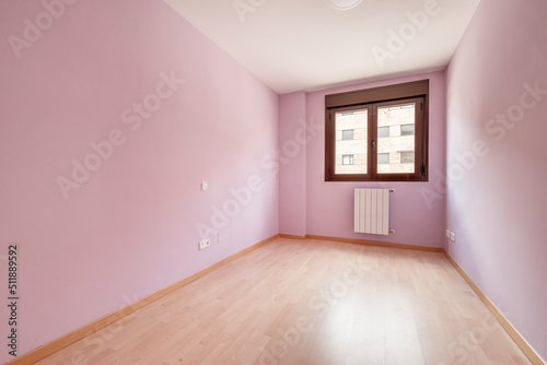 Empty room with bronze colored aluminum window with view, light fuchsia painted walls and light wooden floor