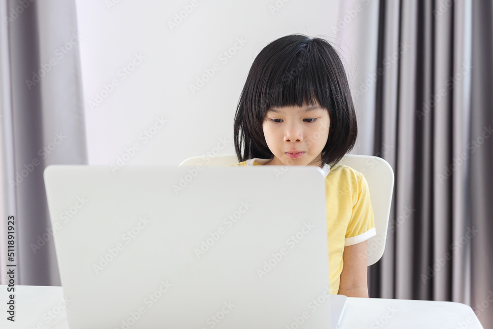 little asian girl student study online using laptop computer at home little asian girl student study online using laptop computer at home