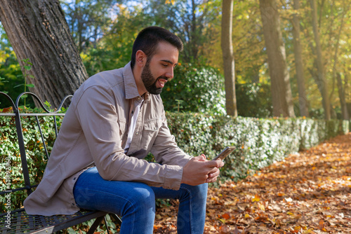 Man sitting using his smartphone