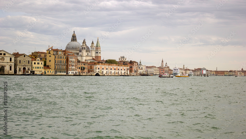 Venice, Italy: Panorama wide angle shot of a city view showing few famous building such as Basilica di san Giorgio Maggiore and doge church from behind at St Mark s square