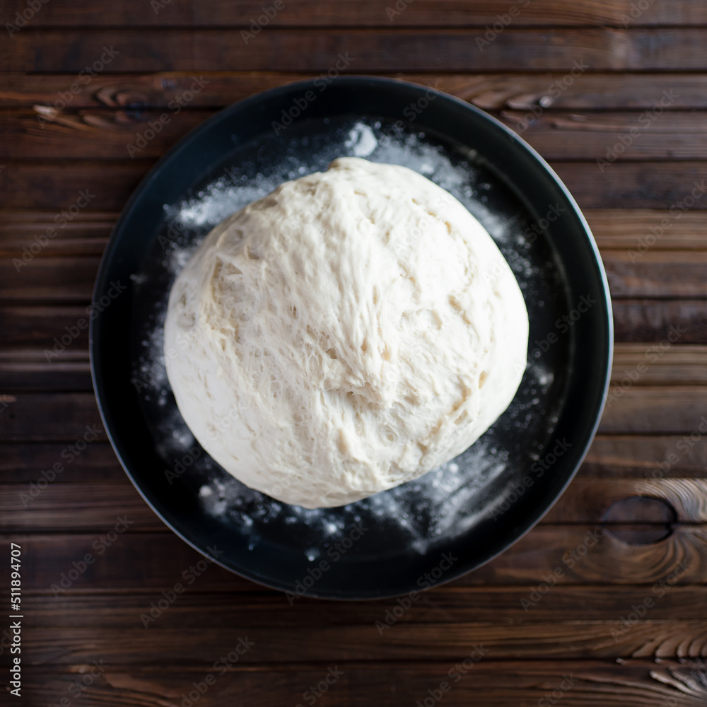 Process of raising the dough in a special basket. Dough made from natural sourdough. Wheat dough. Fermentation. Top view.	