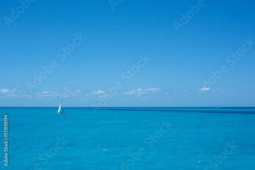 A sailboat on the sea in the tropics against the blue sky of a summer day. Travel vacations