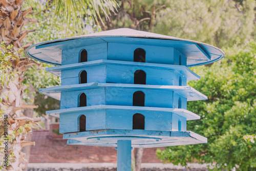 Wooden dovecote in the city park. Taking care of animals and birds photo
