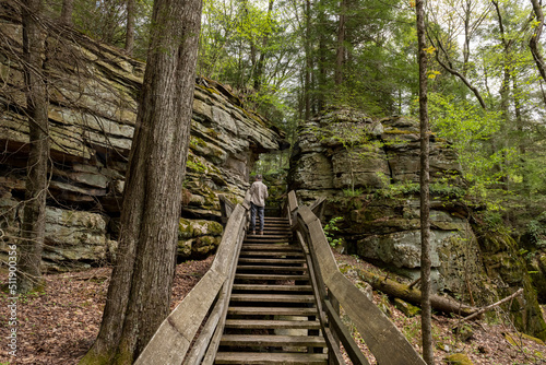 Visitor examining Droop sandstone rocks in Beartown State Park in West Virginia.