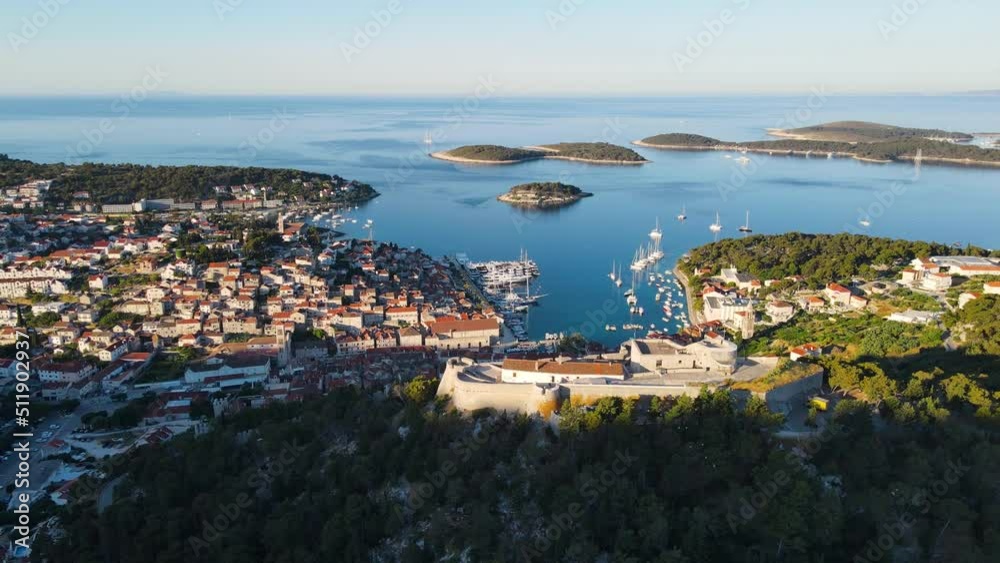 Aerial view of Spanish fortress and old town of Hvar in harbor of Adriatic sea on island Hvar. drone 4k video. Summer vacation destination Aerial view of Spanish fortress and old town of Hvar in harbor of Adriatic sea on island Hvar. drone 4k video. Summer vacation destination