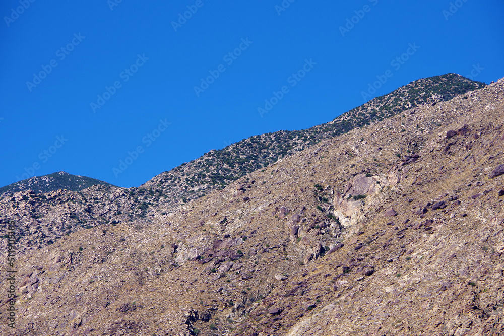 Part of the San Jacinto desert mountains ridge under bright blue sky