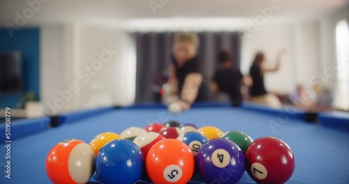 Happy family people enjoying billiard opening break shot at home  Pool Balls with numbers on a pool table  sport activity at home indoors  