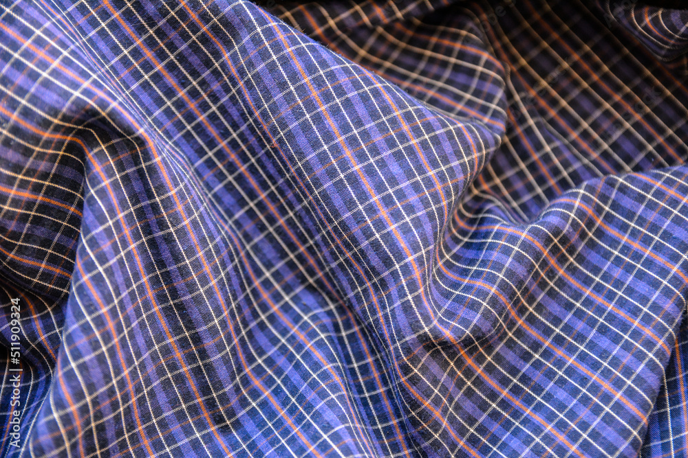 Shirts of different colors are stacked . Shirts of different colors are stacked .