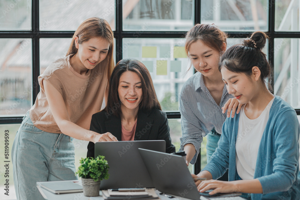 A group of young Asian business women stand and talk. Jointly open a startup company and a business plan management plan to grow the business and be profitable by the concept of the new generation.