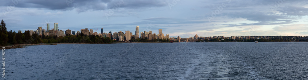 Modern City, Stanley Park, Buildings, beach and Burrard Bridge in False Creek on the West Coast of Pacific Ocean. Downtown Vancouver, British Columbia, Canada. Panoramic View. Sunset Sky