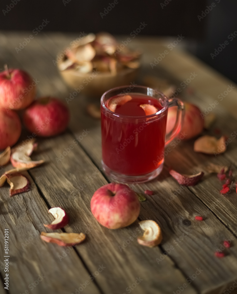 Apple compote in glass on wooden table with dried and fresh apples. Autumn drink apple. Still life