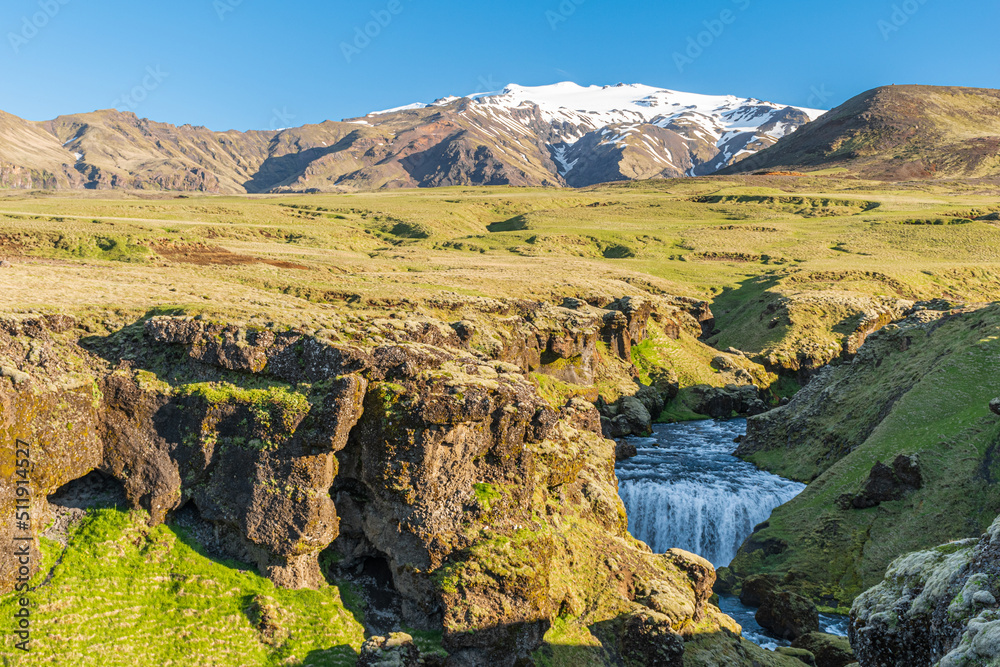 Steinbogafoss waterfall with Eyjafjallajokull glacier in the background along the Fimmvorduhals trail
